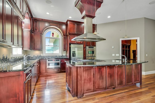 18141 87th Ave N, Maple Grove, MN 55311 - kitchen featuring reddish brown cabinets, appliances with stainless steel finishes, light wood-style floors, and recessed lighting