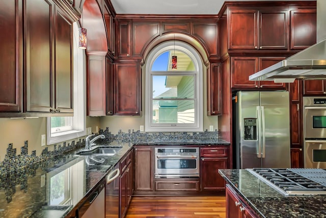 18141 87th Ave N, Maple Grove, MN 55311 - kitchen featuring appliances with stainless steel finishes, dark brown cabinets, a sink, and exhaust hood