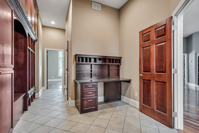 18141 87th Ave N, Maple Grove, MN 55311 - unfurnished office with baseboards, light tile patterned floors, built in study area, a towering ceiling, and recessed lighting