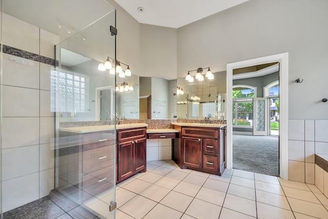 18141 87th Ave N, Maple Grove, MN 55311 - full bath featuring tile patterned floors, vanity, tile walls, and a chandelier