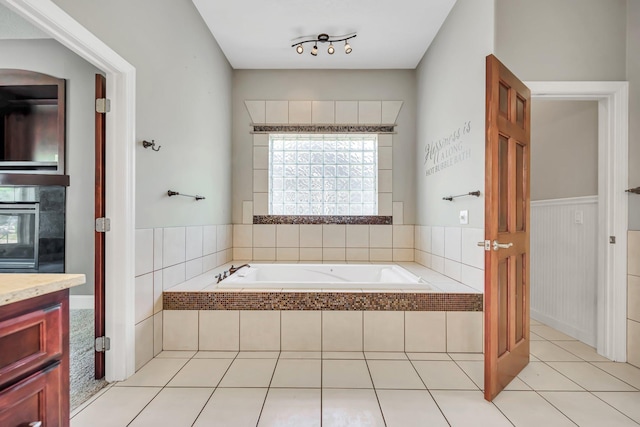 18141 87th Ave N, Maple Grove, MN 55311 - bathroom with a bath, plenty of natural light, vanity, a wainscoted wall, and tile patterned floors