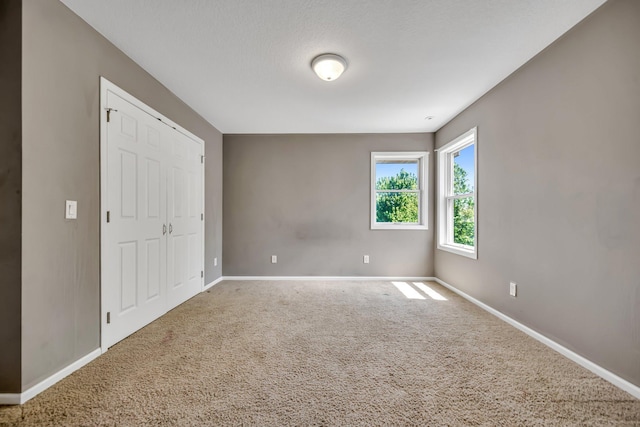 18141 87th Ave N, Maple Grove, MN 55311 - unfurnished bedroom with baseboards, carpet flooring, and a closet