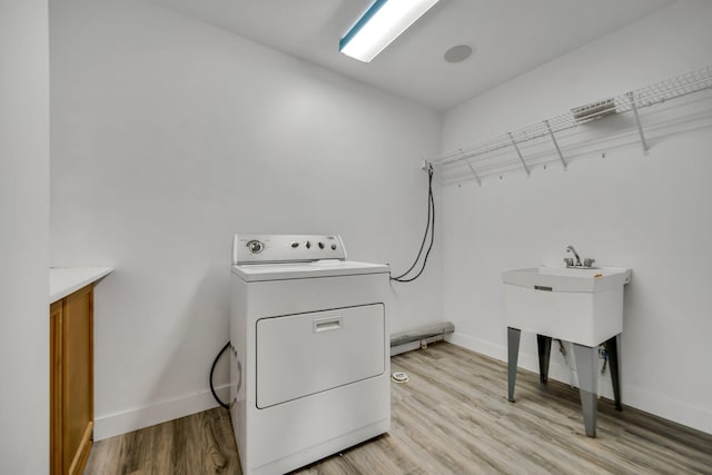 18141 87th Ave N, Maple Grove, MN 55311 - washroom featuring washer / clothes dryer, light wood-style floors, and baseboards