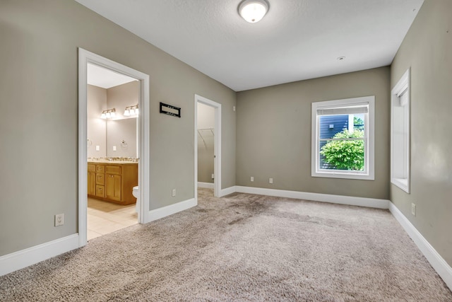 18141 87th Ave N, Maple Grove, MN 55311 - unfurnished bedroom with light colored carpet, a closet, baseboards, and a walk in closet