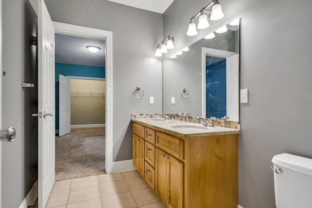 18141 87th Ave N, Maple Grove, MN 55311 - bathroom featuring double vanity, toilet, baseboards, and tile patterned floors