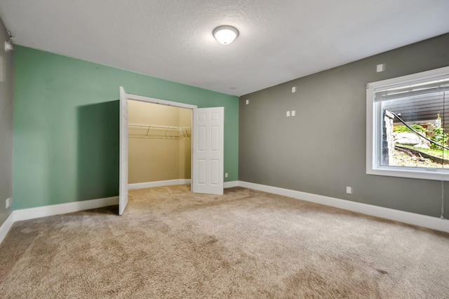 18141 87th Ave N, Maple Grove, MN 55311 - unfurnished bedroom featuring carpet floors, baseboards, a textured ceiling, and a closet