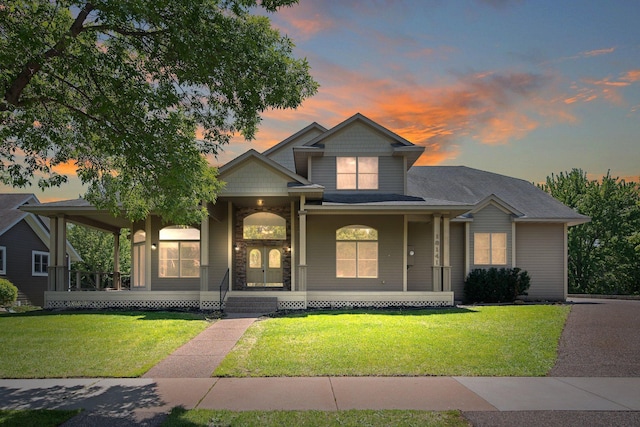 18141 87th Ave N, Maple Grove, MN 55311 - view of front of home featuring a front lawn, covered porch, and stone siding