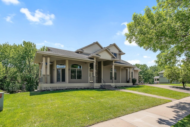 18141 87th Ave N, Maple Grove, MN 55311 - view of front of home with a front lawn, covered porch, roof with shingles, and driveway