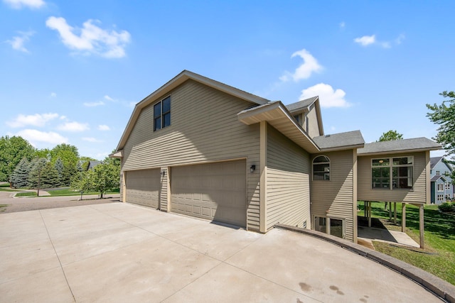 18141 87th Ave N, Maple Grove, MN 55311 - view of side of property with driveway, a garage, and a shingled roof