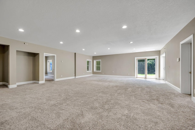 18141 87th Ave N, Maple Grove, MN 55311 - empty room featuring light carpet, recessed lighting, baseboards, and a textured ceiling