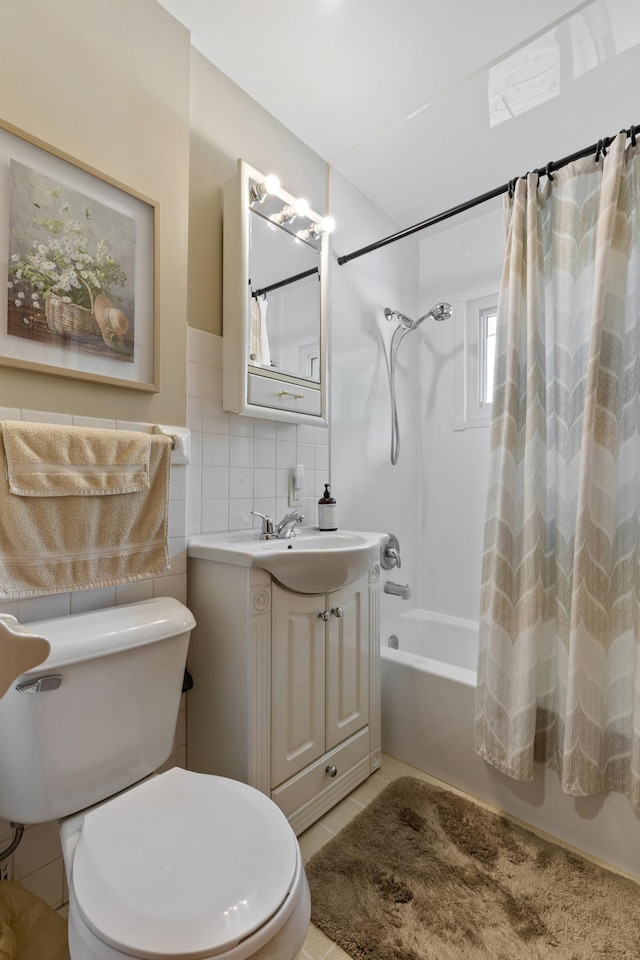 2196 Waukon Ave, Saint Paul, MN 55119 - bathroom with shower / tub combo with curtain, vanity, toilet, tile walls, and tile patterned floors