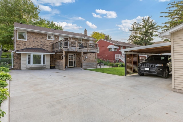 2196 Waukon Ave, Saint Paul, MN 55119 - rear view of property featuring concrete driveway, a wooden deck, a carport, and brick siding