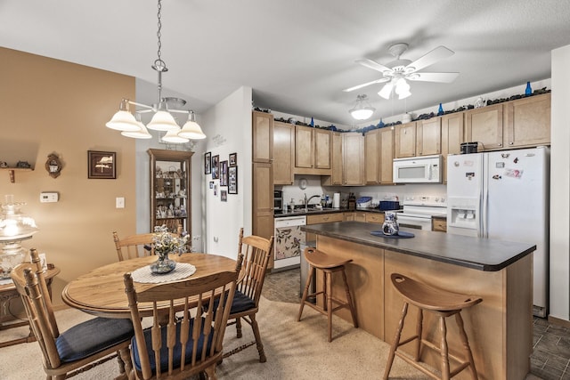 5445 Boone Ave N Unit 216, New Hope, MN 55428 - kitchen featuring white appliances, dark countertops, ceiling fan, and a kitchen breakfast bar