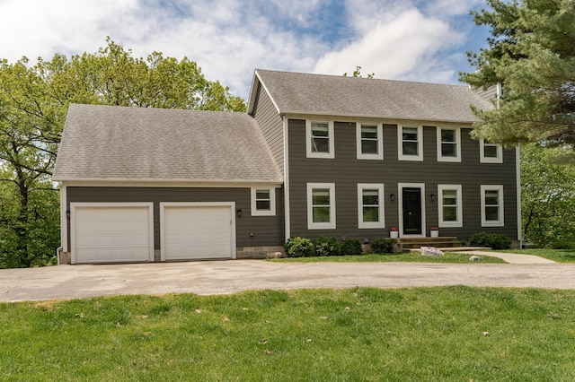 9420 Fabian St NE, Kalmar Twp, MN 55920 - colonial inspired home with driveway, an attached garage, a front yard, and a shingled roof