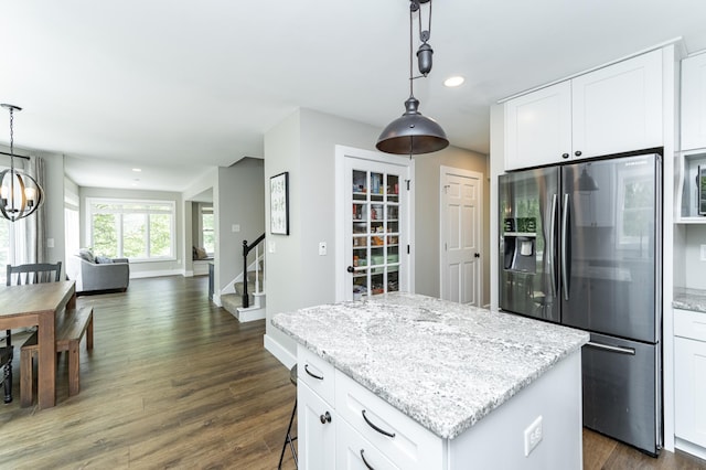 9420 Fabian St NE, Kalmar Twp, MN 55920 - kitchen featuring stainless steel fridge with ice dispenser, a kitchen island, dark wood finished floors, light stone countertops, and white cabinets