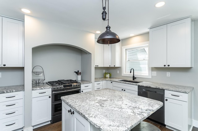 9420 Fabian St NE, Kalmar Twp, MN 55920 - kitchen with range with two ovens, dishwasher, a sink, white cabinetry, and a kitchen island