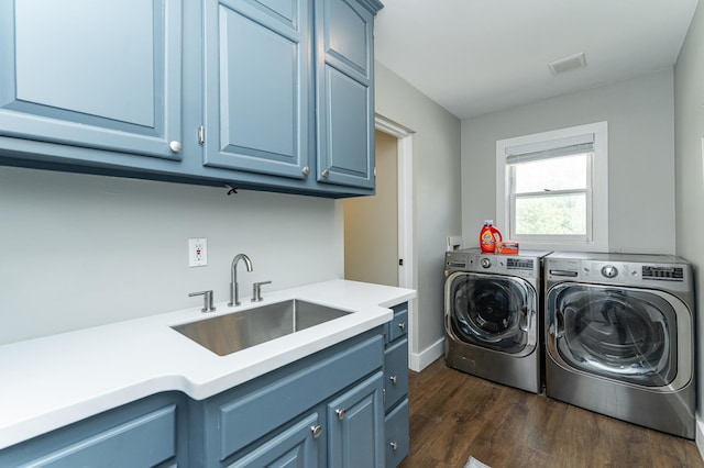 9420 Fabian St NE, Kalmar Twp, MN 55920 - laundry area featuring independent washer and dryer, cabinet space, dark wood-style flooring, and baseboards