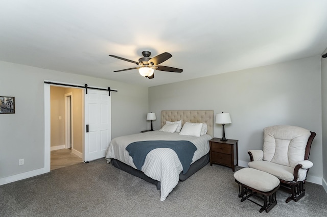 9420 Fabian St NE, Kalmar Twp, MN 55920 - bedroom featuring a barn door, carpet flooring, a ceiling fan, and baseboards