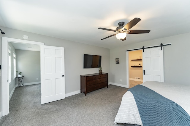 9420 Fabian St NE, Kalmar Twp, MN 55920 - bedroom featuring a barn door, carpet flooring, and baseboards