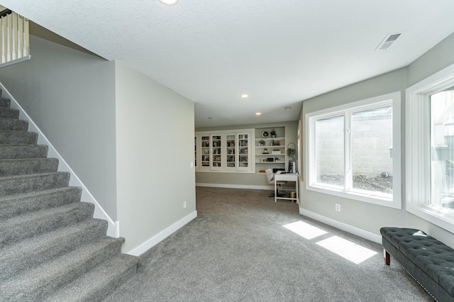 9420 Fabian St NE, Kalmar Twp, MN 55920 - living room with carpet, stairway, baseboards, and recessed lighting
