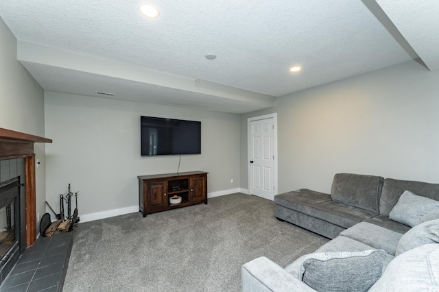 9420 Fabian St NE, Kalmar Twp, MN 55920 - carpeted living room with a tile fireplace, recessed lighting, a textured ceiling, and baseboards