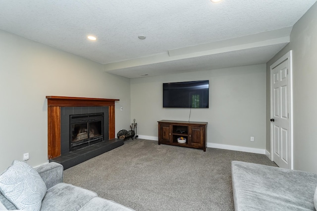 9420 Fabian St NE, Kalmar Twp, MN 55920 - carpeted living room featuring baseboards, recessed lighting, a textured ceiling, and a tile fireplace
