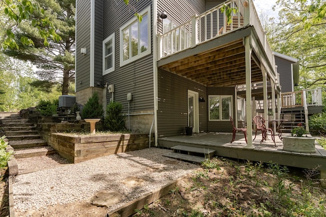 9420 Fabian St NE, Kalmar Twp, MN 55920 - rear view of property featuring stairway, a wooden deck, and central AC unit