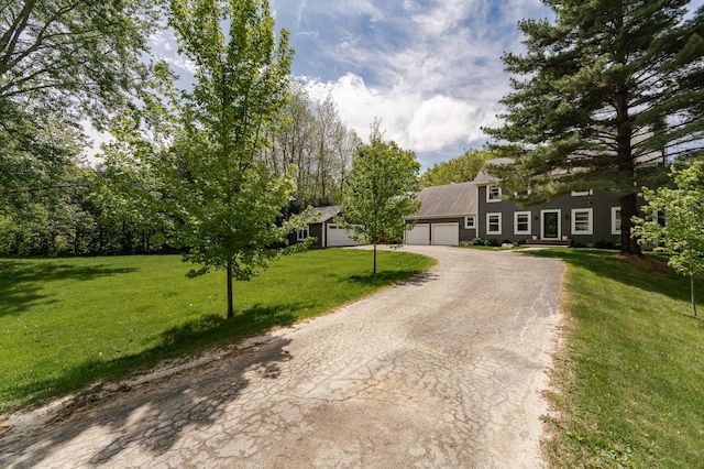 9420 Fabian St NE, Kalmar Twp, MN 55920 - view of front facade featuring an attached garage, driveway, and a front yard