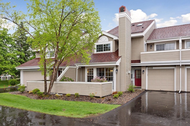 1925 Shenandoah Ct Unit G, Plymouth, MN 55447 - view of front of property with a shingled roof, a chimney, driveway, and a garage
