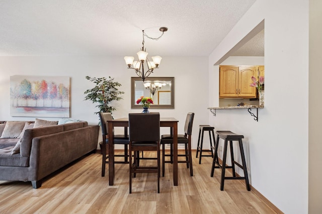 1925 Shenandoah Ct Unit G, Plymouth, MN 55447 - dining area with light wood-type flooring, a chandelier, and a textured ceiling