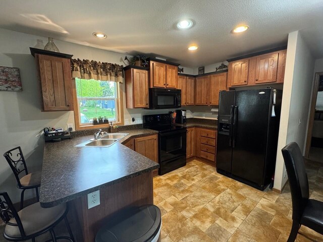 39872 Moose Ln, Wahkon, MN 56386 - kitchen with black appliances, a peninsula, dark countertops, a breakfast bar area, and a sink