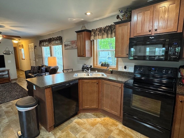 39872 Moose Ln, Wahkon, MN 56386 - kitchen with black appliances, a sink, open floor plan, dark countertops, and healthy amount of natural light