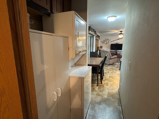 39872 Moose Ln, Wahkon, MN 56386 - kitchen with stacked washing machine and dryer, ceiling fan, and stone finish floors