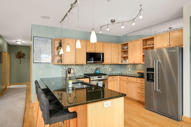 4500 Chicago Ave Unit 311, Minneapolis, MN 55407 - kitchen with stainless steel appliances, open shelves, a sink, and light wood-type flooring