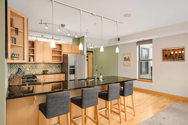 4500 Chicago Ave Unit 311, Minneapolis, MN 55407 - kitchen with high end fridge, open shelves, a sink, a peninsula, and light wood-style floors