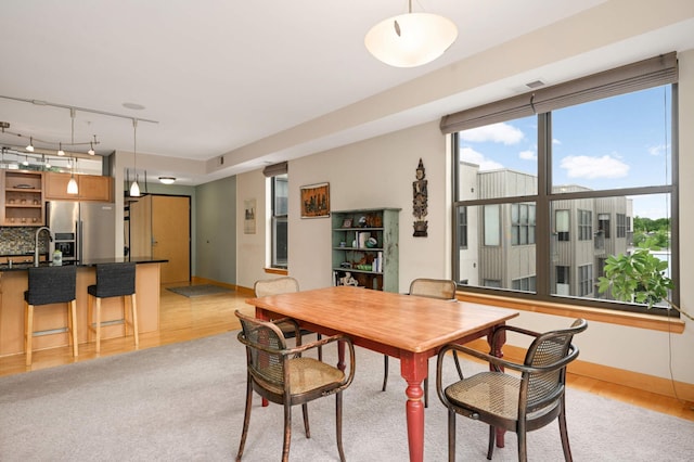 4500 Chicago Ave Unit 311, Minneapolis, MN 55407 - dining space featuring light wood finished floors, rail lighting, and baseboards