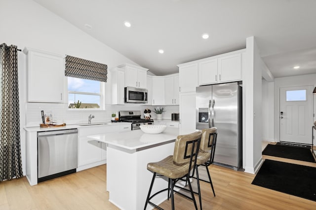 11695 72nd St NE, Otsego, MN 55301 - kitchen featuring stainless steel appliances, a sink, tasteful backsplash, healthy amount of natural light, and lofted ceiling
