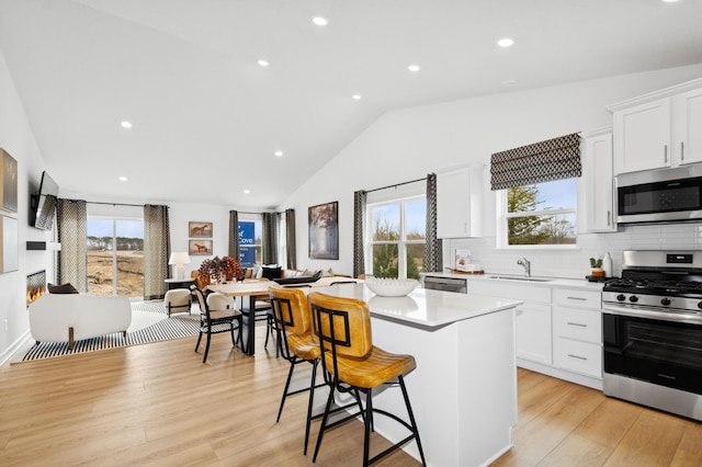 11695 72nd St NE, Otsego, MN 55301 - kitchen featuring stainless steel appliances, a sink, plenty of natural light, light countertops, and lofted ceiling