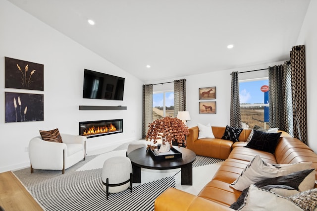 11695 72nd St NE, Otsego, MN 55301 - living area featuring a glass covered fireplace, baseboards, lofted ceiling, wood finished floors, and recessed lighting