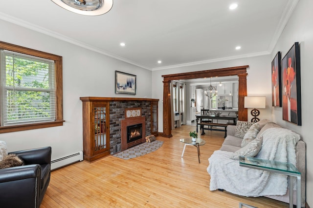 3812 Elliot Ave, Minneapolis, MN 55407 - living area with baseboard heating, wood finished floors, ornamental molding, a chandelier, and recessed lighting