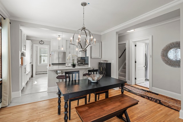 3812 Elliot Ave, Minneapolis, MN 55407 - dining area with stairway, crown molding, a baseboard heating unit, light wood-type flooring, and baseboards