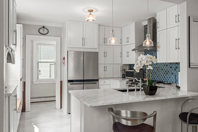3812 Elliot Ave, Minneapolis, MN 55407 - kitchen featuring stainless steel appliances, baseboard heating, a peninsula, a breakfast bar area, and white cabinets