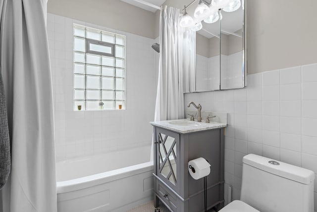 3812 Elliot Ave, Minneapolis, MN 55407 - bathroom with vanity, shower / bathtub combination with curtain, tile walls, and toilet