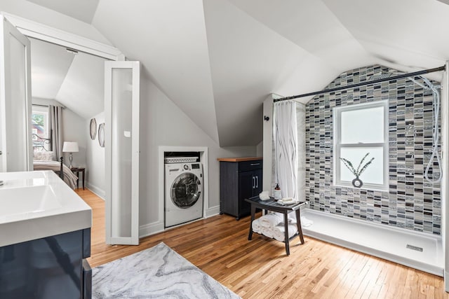 3812 Elliot Ave, Minneapolis, MN 55407 - laundry area with wood finished floors and estacked washer and dryer