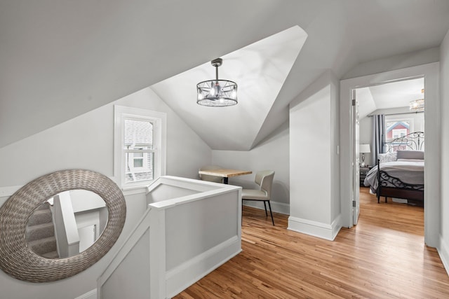 3812 Elliot Ave, Minneapolis, MN 55407 - bonus room featuring lofted ceiling, light wood-type flooring, baseboards, and a chandelier