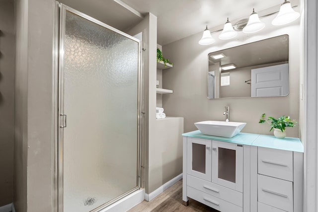 3812 Elliot Ave, Minneapolis, MN 55407 - full bath with wood finished floors, vanity, a shower stall, and baseboards