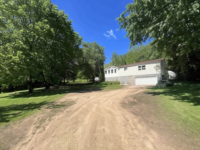 S363 Nicholes Rd, Naples Twp, WI 54755 - view of front of home with dirt driveway, a garage, and a front yard