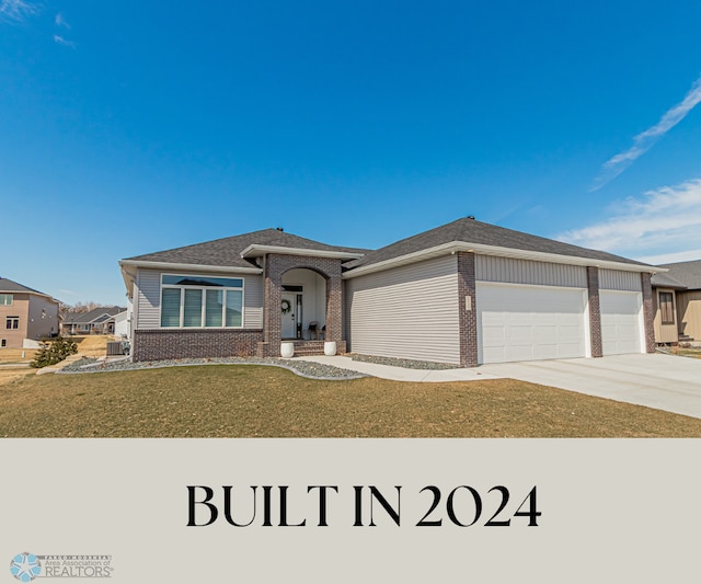 3340 2nd St E, West Fargo, ND 58078 - view of front of home with brick siding, a garage, concrete driveway, a front lawn, and a shingled roof