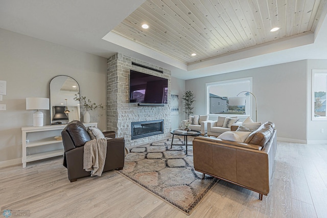 3340 2nd St E, West Fargo, ND 58078 - living area with a raised ceiling, wooden ceiling, wood finished floors, baseboards, and a large fireplace