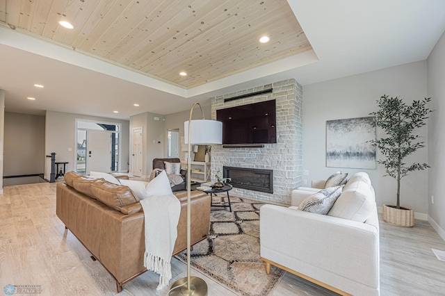 3340 2nd St E, West Fargo, ND 58078 - living room with recessed lighting, a fireplace, light wood-style flooring, wood ceiling, and a tray ceiling